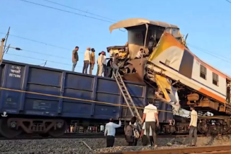 Rescue teams and railway staff near damaged train coaches during Bilaspur train collision incident