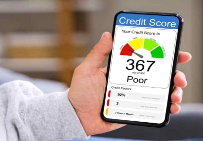 A young borrower reviewing credit-builder loan options on a smartphone to improve credit score in India.