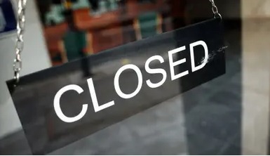 Closed bank branch shutter with election day polling station in the background indicating November 6 bank holiday in Bihar.