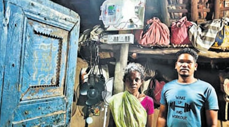 Tribal families in Alluri Sitarama Raju district walking along newly constructed road with village surroundings