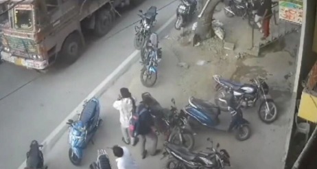 Accident scene showing bike collision with truck at busy intersection in Andhra Pradesh