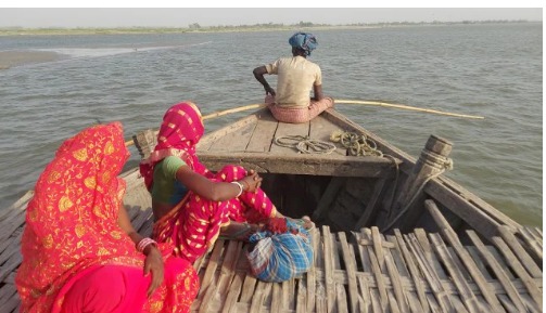 Bihar town residents using boats to reach polling stations amid waterlogged roads during elections 2025.
