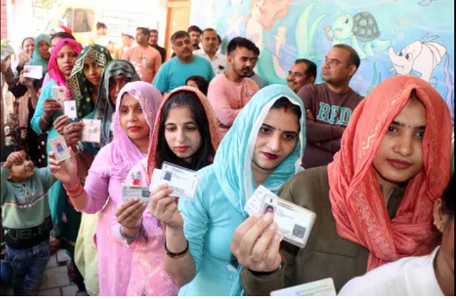 Polling booth in Haryana with election officials monitoring voting amid reports of irregularities.