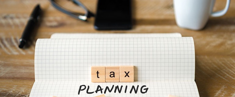 Taxpayer checking advance tax liability under new regime on laptop