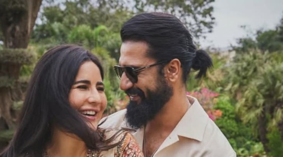 Katrina Kaif and Vicky Kaushal smiling together at an event, representing their joy as they welcome their baby boy.