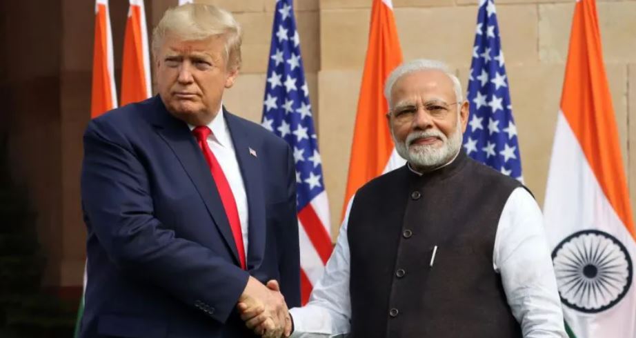 “Donald Trump and Narendra Modi shaking hands during a diplomatic meeting in New Delhi, India.”