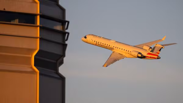 Alt text: “Passengers waiting at airport terminal as flights are cancelled under FAA directive”