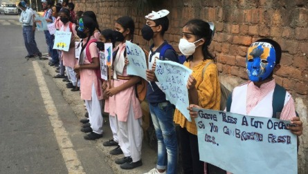 Protestors in Delhi wear masks and hold placards demanding action as air pollution reaches severe levels.