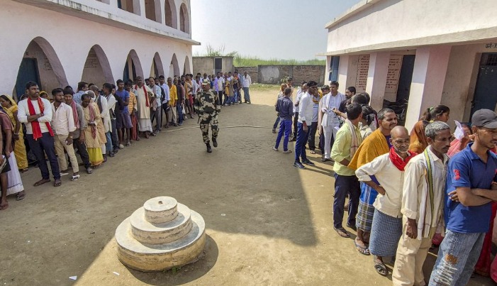 Voters queue outside a polling booth during Bihar Assembly Election Phase 2, 2025.