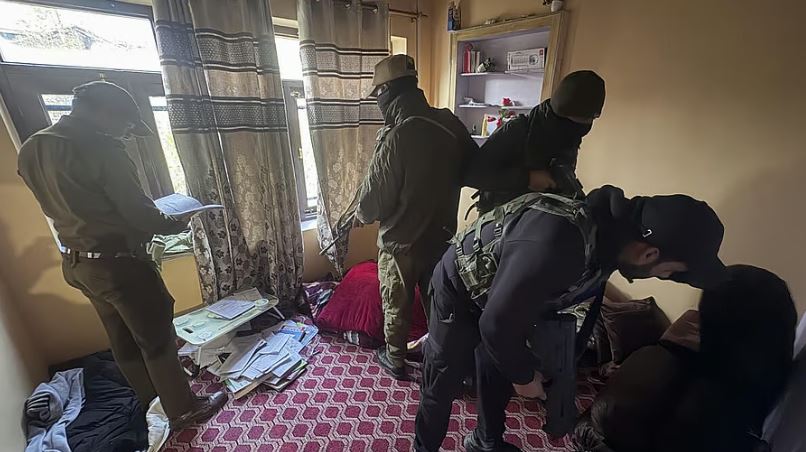 Police officers conduct raids on Jamaat-e-Islami members' residences in Jammu and Kashmir
