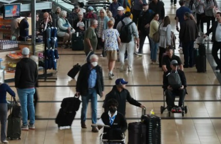 Passengers waiting at a crowded US airport as flights are delayed amid the ongoing government shutdown and FAA flight cuts