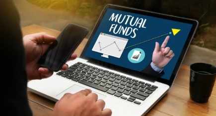 Investor transferring mutual fund units online using a laptop through AMC or CAMS platform.
