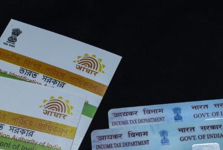 Person checking Aadhaar security and authentication history on a mobile device.