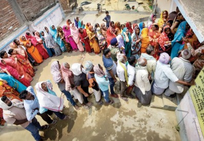 Voters standing in queue during Bihar Assembly Election 2025 reflecting caste and alliance shifts.
