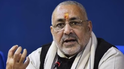 Giriraj Singh addressing media on election results in Bihar with redevelopment plans in the background.