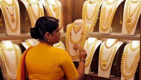 Gold ornaments and coins representing 18K, 22K and 24K gold rates in India on November 14.