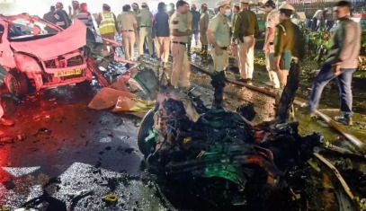 Forensic team inspecting blast site near Red Fort after ammonium nitrate and petroleum traces found.