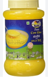 Counterfeit ghee containers seized during raid in Bengaluru with officials inspecting them.