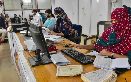 Revenue department office staff discussing official paperwork and workload concerns in Tamil Nadu administrative setup.