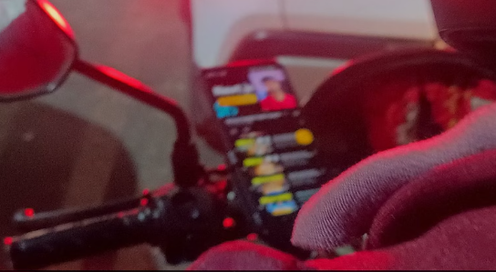 Rapido rider learning coding on his phone during a ride in Bengaluru