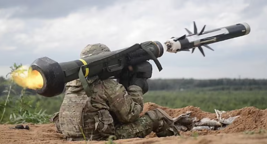 US flag and Indian flag behind Javelin missile and Excalibur artillery round
