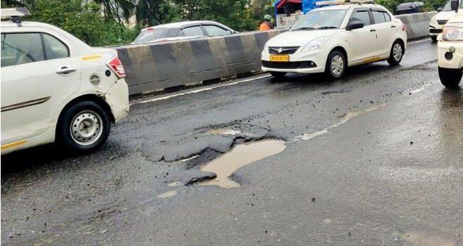 Damaged Bengaluru road with pothole where fatal accident occurred