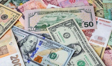 Indian rupees and US dollar notes placed together for travel savings