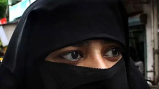 Australian far-right senator entering Parliament wearing a burqa, causing outrage among lawmakers.