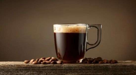 A hot cup of bullet coffee showing butter and MCT oil representing its health benefits and risks.