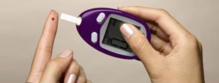 Person eating mindfully at a table to prevent blood sugar spikes