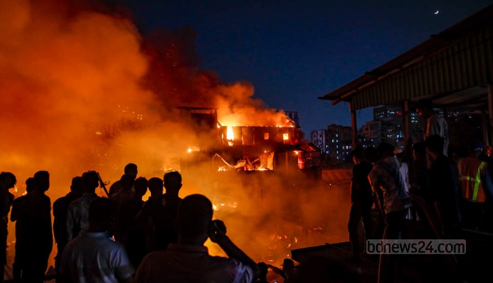 Firefighters battling large slum fire in Bangladesh at night
