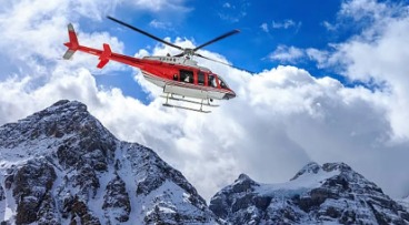Helicopter flying in foggy Himalayan terrain near Kedarnath